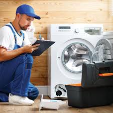 Technician writing an estimate on a tablet next to a front-load washer